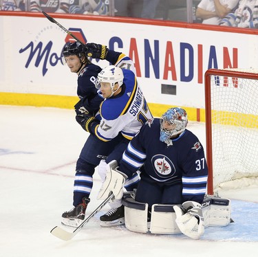WINNIPEG, MANITOBA - APRIL 10: Jaden Schwartz #17 of the St. Louis Blues battles for space with Connor Hellebuyck #37 and Jacob Trouba #8 of the Winnipeg Jets in Game One of the Western Conference First Round during the 2019 NHL Stanley Cup Playoffs at Bell MTS Place on April 10, 2019 in Winnipeg, Manitoba, Canada. (Photo by Jason Halstead/Getty Images)