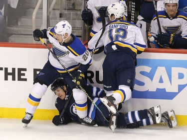 WINNIPEG, MANITOBA - APRIL 10: Par Lindholm #22 of the Winnipeg Jets looks up from the ice under Alexander Steen #20 and Zach Sanford #12 of the St. Louis Blues in Game One of the Western Conference First Round during the 2019 NHL Stanley Cup Playoffs at Bell MTS Place on April 10, 2019 in Winnipeg, Manitoba, Canada. (Photo by Jason Halstead/Getty Images)