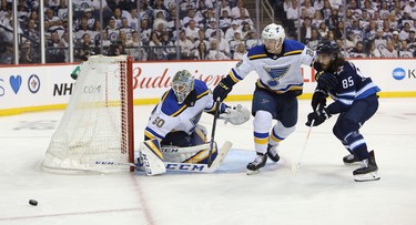 WINNIPEG, MANITOBA - APRIL 10: Mathieu Perreault #85 of the Winnipeg Jets looks for a rebound in front of Jordan Binnington #50 and Vince Dunn #29 of the St. Louis Blues in Game One of the Western Conference First Round during the 2019 NHL Stanley Cup Playoffs at Bell MTS Place on April 10, 2019 in Winnipeg, Manitoba, Canada. (Photo by Jason Halstead/Getty Images)