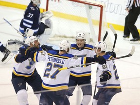 WINNIPEG, MANITOBA - APRIL 10: Tyler Bozak #21 of the St. Louis Blues and teammates celebrate Bozak's goal against the Winnipeg Jets in Game One of the Western Conference First Round during the 2019 NHL Stanley Cup Playoffs at Bell MTS Place on April 10, 2019 in Winnipeg, Manitoba, Canada.
