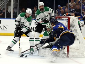 Dallas Stars goaltender Ben Bishop makes the save on St. Louis Blues' Robert Thomas on Saturday afternoon in St. Louis. (Jeff Roberson/The Associated Press)
