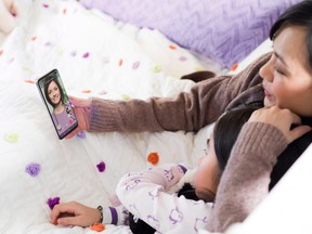 A mother and daughter use the Babylon by Telus Health app in this undated handout photo. Telus Health estimates that more than 50 per cent of general practice doctors offices in Canada use the electronic medical records software at their office; more than 60 per cent of pharmacies use its pharmacy management software. It's now adding Babylon by Telus Health, which including video visits by smartphone, to its lineup. THE CANADIAN PRESS/Telus *MANDATORY CREDIT* ORG XMIT: CPT501