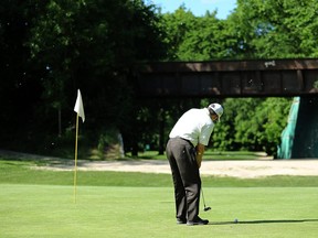 A golfer putts on the 10th hole at Kildonan Park Golf Course, which features an abandoned train bridge, on Mon., June 19, 2017. Kevin King/Winnipeg Sun/Postmedia Network