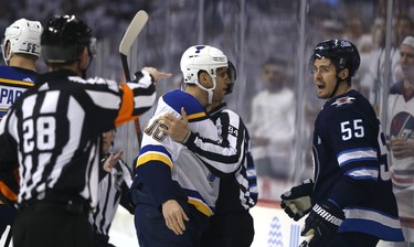 Winnipeg Jets centre Mark Scheifele (right) is challenged by St. Louis Blues forward Brayden Schenn as he is getting a penalty for bumping Blues goaltender Jordan Binnington during Game 1 of Round 1 of the NHL playoffs in Winnipeg on Wed., April 10, 2019. Kevin King/Winnipeg Sun/Postmedia Network