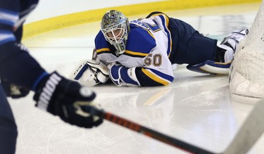 St. Louis Blues goaltender Jordan Binnington looks up at the referee after getting bumped by Winnipeg Jets centre Mark Scheifele during Game 1 of Round 1 of the NHL playoffs in Winnipeg on Wed., April 10, 2019. Kevin King/Winnipeg Sun/Postmedia Network