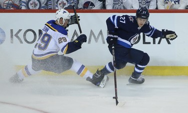 Winnipeg Jets forward Nik Ehlers (right) spins away from  St. Louis Blues defenceman Vince Dunn during Game 1 of Round 1 of the NHL playoffs in Winnipeg on Wed., April 10, 2019. Kevin King/Winnipeg Sun/Postmedia Network