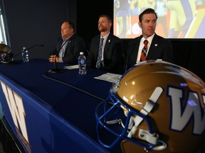 Winnipeg Blue Bombers president/CEO Wade Miller, head coach Mike O'Shea and general manager Kyle Walters (from left) take their seats at the 2019 Fan Forum in the Pinnacle Room at Investors Group Field in Winnipeg on Tuesday.