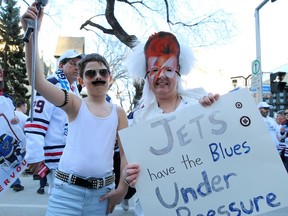 Tracey Thiele, as David Bowie, and son Blake, 10, as Freddie Mercury, are a dynamic duo at the Winnipeg Whiteout Street Party before the Winnipeg Jets and St. Louis Blues played Game 5 of the first round of the NHL playoffs in Winnipeg on Thursday.
