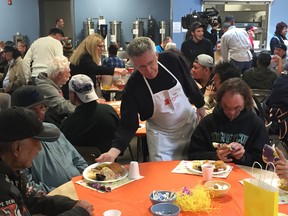 A volunteer from the Manitoba Real Estate Association serves Easter lunch at the Siloam Mission on Monday. Volunteers and staff at Siloam Mission were joined by members of the Manitoba Real Estate Association, who provided financial and volunteer support for Monday's lunch service.