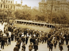 People take a street car off the tracks during the Winnipeg General Strike of 1919.
Archives of Manitoba