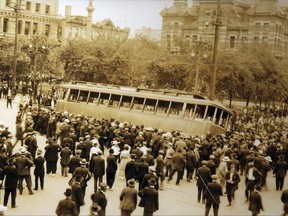 People take a street car off the tracks during the Winnipeg General Strike of 1919.