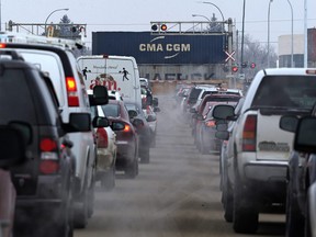 Vehicles queue at the train crossing on Waverley Street near Taylor Avenue on Wed., Jan. 20, 2016. Underpass construction is under budget and the city is lobbying to spend that extra cash on other local projects.