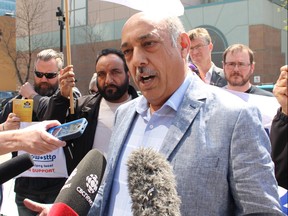 Aleem Chaudhary, president of the Amalgamated Transit Union Local 1505, stands with union members and supporters at the Graham Avenue Transit Mall on Monday, May 13, 2019. The union has advised drivers not to demand payment from their riders on Tuesday, May 14, 2019, as part of a labour action against the city. The two sides are in the midst of a labour dispute, after the union rejected the city's most recent offer. Joyanne Pursaga/Winnipeg Sun/Postmedia Network