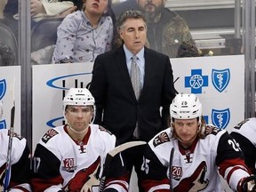 FILE - In this Dec. 12, 2016, file photo, Arizona Coyotes coach Dave Tippett stands behind his bench during the team&#039;s NHL hockey game against the Pittsburgh Penguins in Pittsburgh. The Coyotes and Tippett have mutually agreed to part ways after eight seasons. The 55-year-old Tippett led the Coyotes through four years of being run by the NHL after the team went into bankruptcy and took the Coyotes to the 2012 Western Conference Finals. He went 282-257-83 in the desert. (AP Photo/Gene J. Puskar,