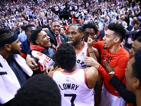 Kawhi Leonard celebrates with Toronto Raptors teammates after winning Game 7 on Sunday. (GETTY IMAGES)