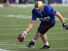 Jake Thomas gets his hand on a fumble to knock it out of bounds during a drill at Winnipeg Blue Bombers training camp on Wednesday. (KEVIN KING/Winnipeg Sun)