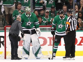 Dallas stars head trainer Dave Zeis (left) checks on Ben Bishop during the third period of Game 6 against the St. Louis Blues. Bishop took a shot in the collarbone and had to leave the game. He will play in Game 7. (Ronald Martinez/Getty Images)