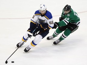 St. Louis Blues' Colton Parayko handles the puck as Dallas Stars' Jason Dickinson defends during the third period in Game 4 of an NHL second-round hockey playoff series, Wednesday, May 1, 2019, in Dallas.