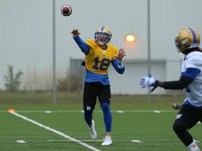 Quarterback Bryan Bennett leads receiver Lucky Whitehead with a pass during Blue Bombers rookie camp on the University of Manitoba campus on Wednesday. (KEVIN KING/WINNIPEG SUN)