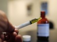 A syringe loaded with a dose of CBD oil is shown in a research laboratory at Colorado State University in Fort Collins, Colo., on Nov. 6, 2017.