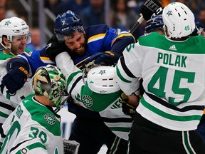 Pat Maroon of the St. Louis Blues scuffles with Miro Heiskanen (4) and Roman Polak (45) of the Dallas Stars in Game 5 of the Western Conference Second Round during the 2019 NHL Stanley Cup Playoffs on Friday.