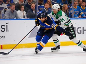 Ryan O'Reilly (90) of the St. Louis Blues fights off Roope Hintz (24) of the Dallas Stars as he controls the puck in Game 5 of the Western Conference Second Round during the 2019 NHL Stanley Cup Playoffs on Friday.