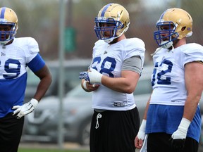 Offensive linemen Kendall Calhoun (left), Geoff Gray (centre), Kendall Calhoun and Cody Speller listen to instructions during Blue Bombers rookie camp on the University of Manitoba campus on Wednesday. Gray is aiming to be a starter. (KEVIN KING/WINNIPEG SUN)
