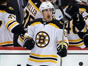 Boston Bruins' Brad Marchand returns to the bench after scoring in the second period of an NHL game against the Pittsburgh Penguins on Jan. 7, 2018