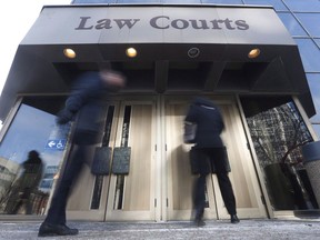 People enter the Law Courts in Winnipeg on Monday, February 5, 2018. A man has been sentenced to 13 years in prison for his role in the death of an Indigenous woman who was killed during a botched robbery.Jeanenne Fontaine, who was 29, was shot and her Winnipeg home set on fire in 2017 when three men came to her house to collect on a drug debt her boyfriend owed.