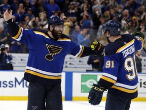 Blues left wing Pat Maroon (left) and right wing Vladimir Tarasenko (right) celebrate the team's 2-1 win against the Stars in double overtime in Game 7 of an NHL second-round playoff series in St. Louis on Tuesday, May 7, 2019.