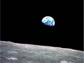 This Dec. 24, 1968, file photo shows the Earth behind the surface of the moon during the Apollo 8 mission. The image fostered a new popular consciousness, framing the early environmental movement in the 1960s. (William Anders/NASA via AP, File)