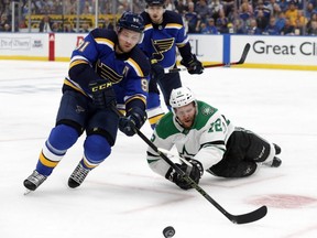 Blues right wing Vladimir Tarasenko (left) and Stars centre Radek Faksa (right) compete for control of the puck as Ivan Barbashev (rear) watches during the first period in Game 7 of an NHL second-round playoff series in St. Louis, Tuesday, May 7, 2019.