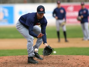 Pitcher Mitchell Aker fields a grounder during Winnipeg Goldeyes spring training camp at Shaw Park in Winnipeg.