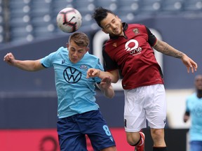 Halifax Wanderers FC's Elliot Simmons (left) in action with Valour FC's Marco Bustos, in Winnipeg. Saturday, May 11.