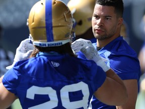 Derek Jones (right) chats with Jeff Hecht during Winnipeg Blue Bombers training camp at IG Field on Tuesday.