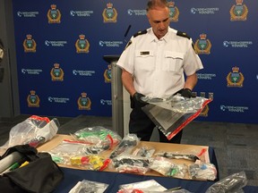 Insp. Max Waddell of the Organized Crime Division shows off a collection of 11 improvised firearms and an assortment of firearm parts in various stages of completion at a press briefing at the police headquarters in Winnipeg on Tuesday.