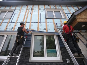 Builders work on a Habitat for Humanity home construction project in Winnipeg. Winnipeg Sun/Chris Procaylo/stf