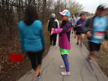 A volunteer works to keep five-kilometre walk participants separated from the 10-kilometre runners during the Winnipeg Run for Women, held at Centre scolaire Leo-Remillard in Winnipeg, on Sun., May 12, 2019. There were over 1,600 people registered to participate, with pledges and donations supporting mental health programs at Mood Disorders Association of Manitoba. Kevin King/Winnipeg Sun/Postmedia Network