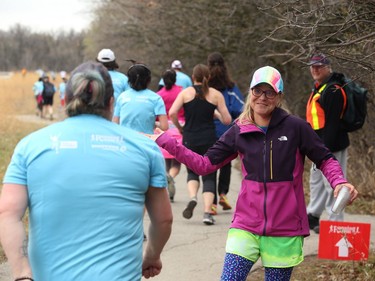 A volunteer with a high-five at the ready during the Winnipeg Run for Women, held at Centre scolaire Leo-Remillard in Winnipeg, on Sun., May 12, 2019. There were over 1,600 people registered to participate, with pledges and donations supporting mental health programs at Mood Disorders Association of Manitoba. Kevin King/Winnipeg Sun/Postmedia Network