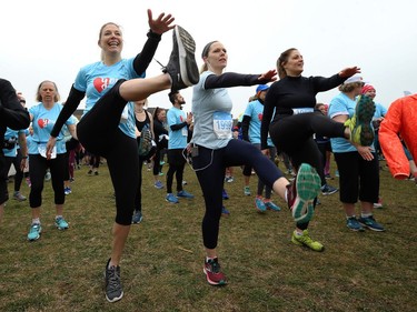 Shelly Roy, Tracy Bellyou and Kristi Aiello (from left) take part in the warmup prior to the Winnipeg Run for Women, held at Centre scolaire Leo-Remillard in Winnipeg, on Sun., May 12, 2019. There were over 1,600 people registered to participate, with pledges and donations supporting mental health programs at Mood Disorders Association of Manitoba. Kevin King/Winnipeg Sun/Postmedia Network