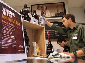 A Liquor Mart employee fills a growler. Soon growler sales will be left to private retailers.