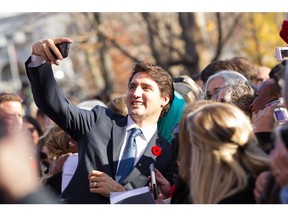 Prime Minister Justin Trudeau takes a selfie as he greets the crowd outside Rideau Hall after being sworn in as Canada's 23rd Prime Minister in Ottawa, Ontario, November 4, 2015. AFP PHOTO/ GEOFF ROBINSGEOFF ROBINS/AFP/Getty Images