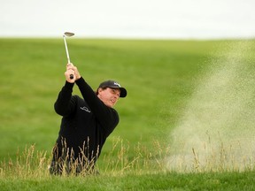 Phil Mickelson of the United States plays a shot from a bunker on the 11th hole during the third round of the 2019 U.S. Open at Pebble Beach Golf Links on June 15, 2019 in Pebble Beach, California.