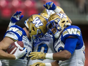 Blue Bombers' Drew Wolitarsky (82) celebrates his touchdown against the B.C. Lions with teammates Nic Demski (10) and Anthony Gaitor (23) during the second half CFL football action in Vancouver, B.C., on Saturday. THE CANADIAN PRESS/Ben Nelms