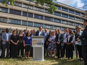 Surrounded by 25 NDP candidates, NDP leader Wab Kinew launches the party's unofficial election campaign in front of the Misericordia Health Centre in Winnipeg on June 23, 2019