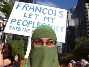 People protest Quebec's new Bill 21, which will ban teachers, police, government lawyers and others in positions of authority from wearing religious symbols such as Muslim head coverings and Sikh turbans, in Montreal, Quebec, Canada, June 17, 2019. (REUTERS/Christinne Muschi)