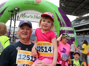 Bryan Harmer holds Monica Harmer after the duo completed the Super Run at the 41st annual Manitoba Marathon in Winnipeg, Man., on Sunday, June 16, 2019.