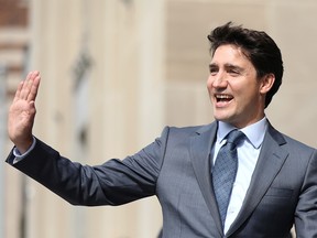Prime Minister Justin Trudeau waves while walking to a news conference about the government's decision on the Trans Mountain Expansion Project in Ottawa, June 18, 2019. REUTERS/Chris Wattie