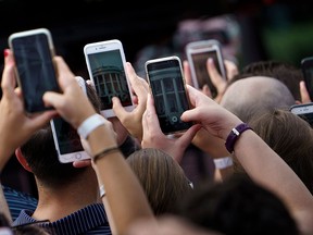 People listen as President Donald Trump speaks during an Independence Day picnic for military families at the White House July 4, 2018 in Washington. (BRENDAN SMIALOWSKI/AFP/Getty Images) u.s. government mobile cell phone cellphone celphone privacy telecommunications