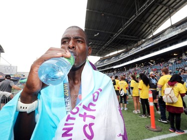 David Mutai, who lives Edobicoke, Ont., enjoys a sip of water after winning the Men's Full Marathon at the 41st Manitoba Marathon in Winnipeg, Man., on Sunday, June 16, 2019.
